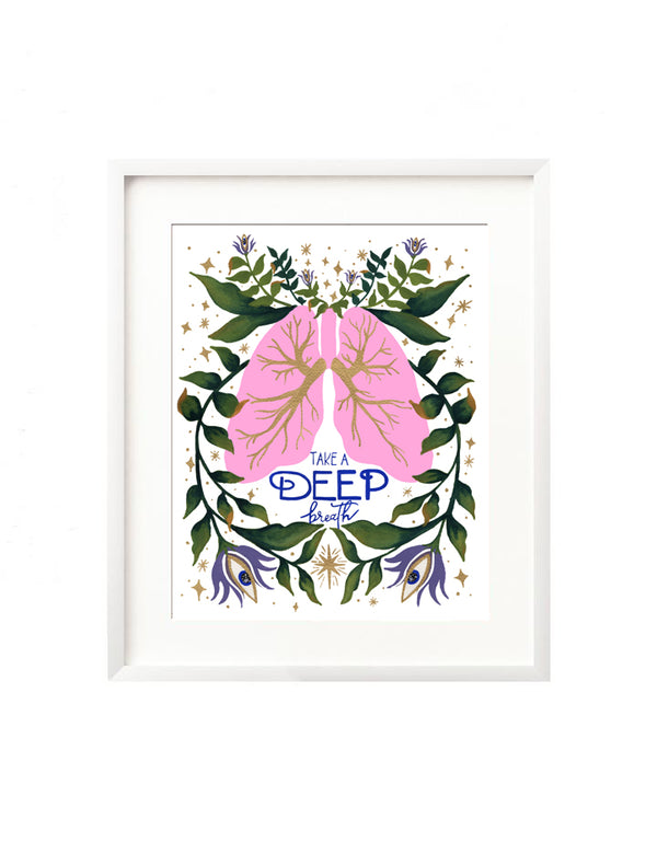 A framed art print - the illustration is a pair of pink lungs with vibrant florals and greenery being breathed out. There are twinkles and stars surrounding, and the hand lettered message "Take a deep breath". A reminder of the yoga principals of centering with your breath. The only moment is now.